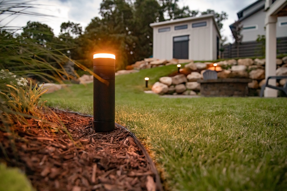 A smarty light on a lawn lighting the garden